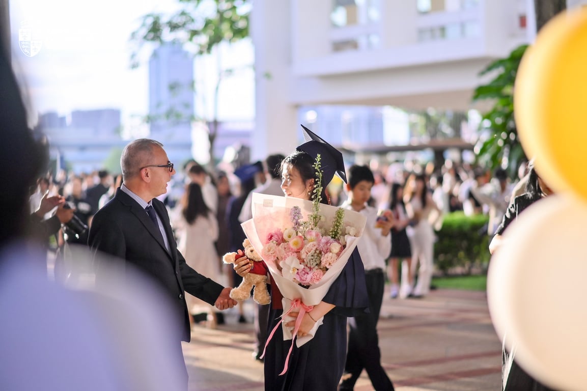 Graduate and parent share a moment after the celebration.