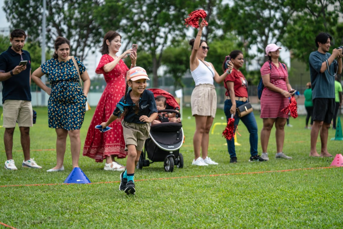 Parents cheering on their children at the annual Sports Day event