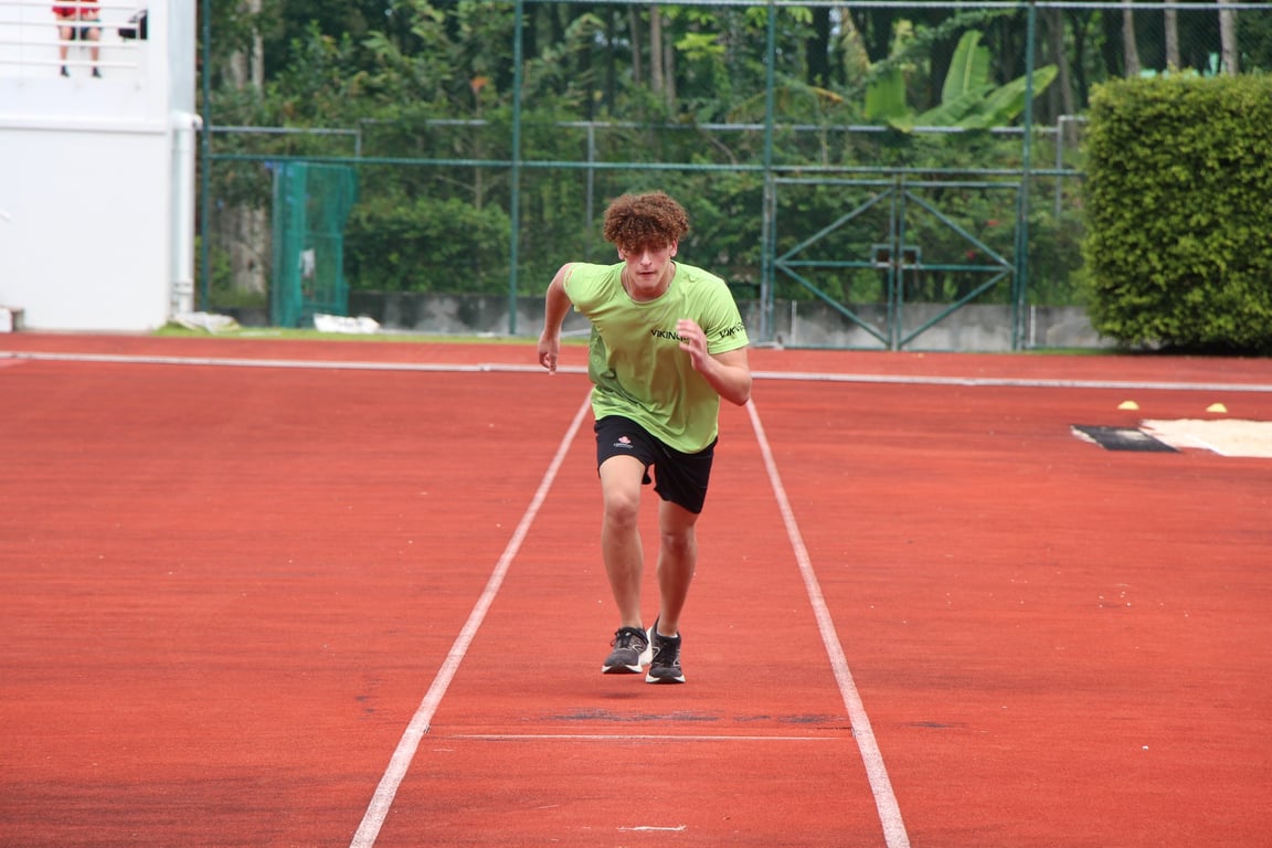 Student running on the track during school Sports Day.