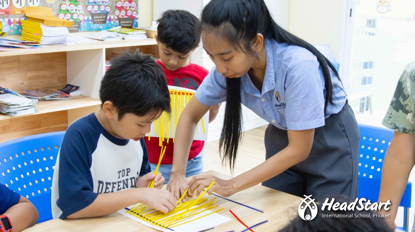 Students in the Thai Culture Club learning traditional Isaan bamboo weaving.