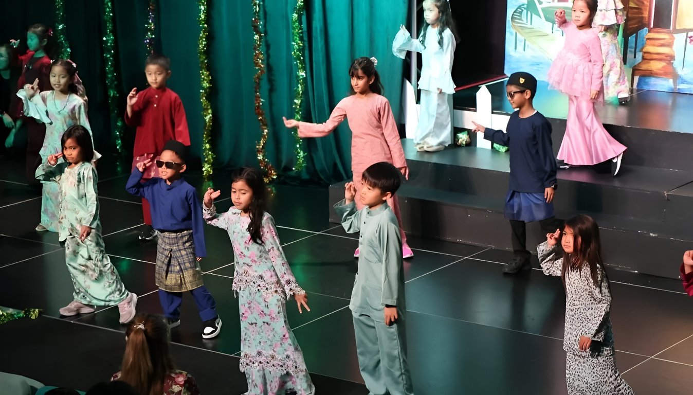 Primary students giving a performance at a Hari Raya Celebration.