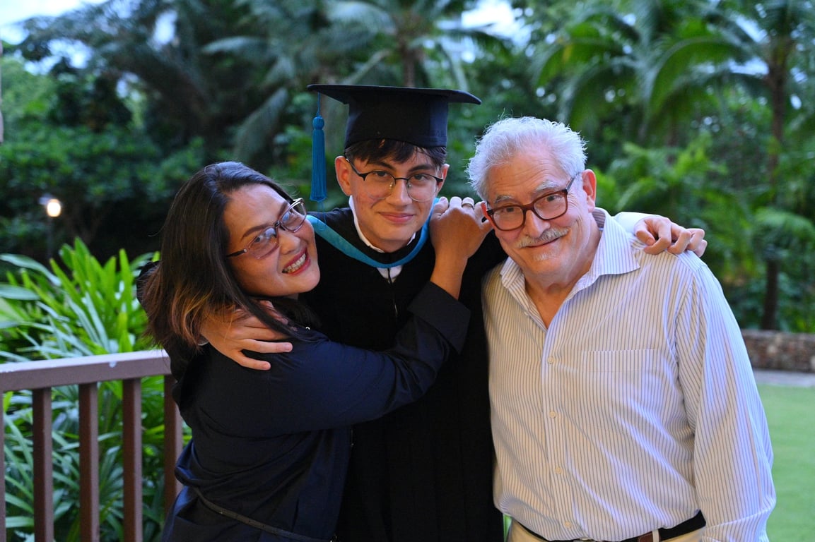 Graduate celebrating with family at the Year 13 Graduation Ceremony.