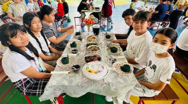 roup of students enjoying a cultural dining activity together.