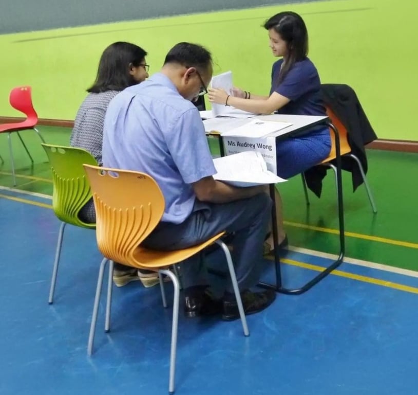 Parents meeting a teacher during a parent-teacher conference