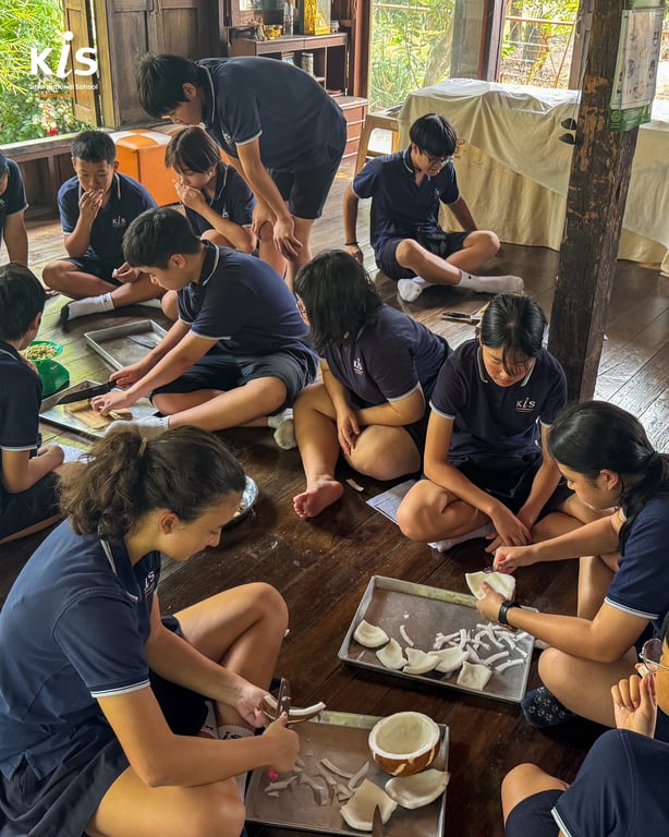 Students engaged in hands-on coconut carving activity