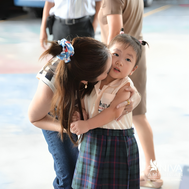 A warm send off by a parent as young student arrives at school.