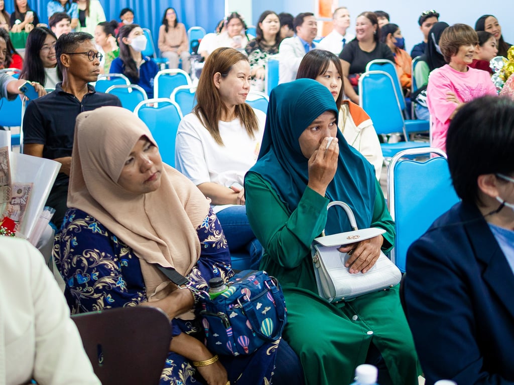 Parents attending graduation ceremony.