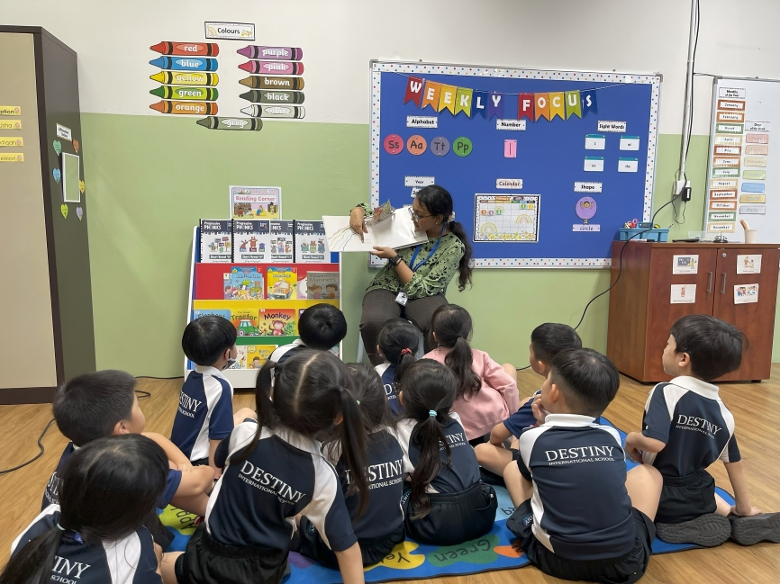 Preschool children gather around their teacher for story time, listening intently as part of their language development routine.