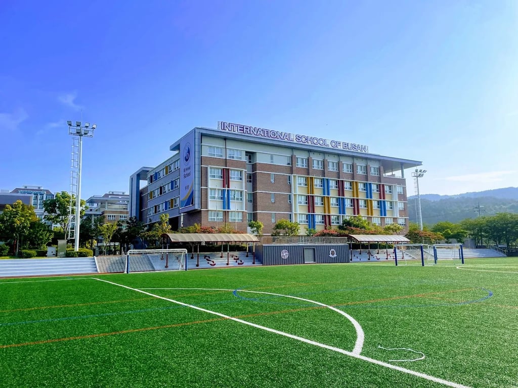 International School of Busan campus overlooking the athletic field.