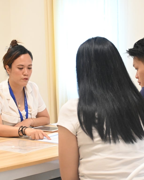 A member of the school team engages with parents during a PTA meeting.