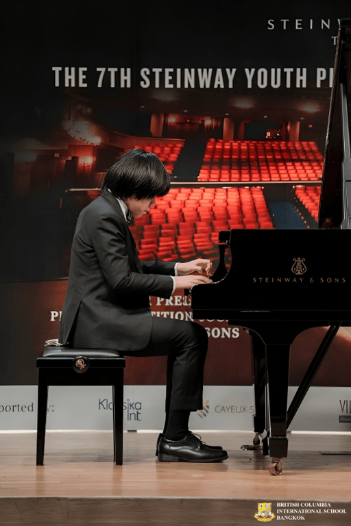 Student performs a piano recital on stage.