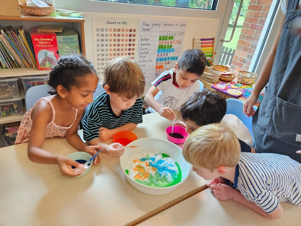 Children experimenting with different colours in a group activity