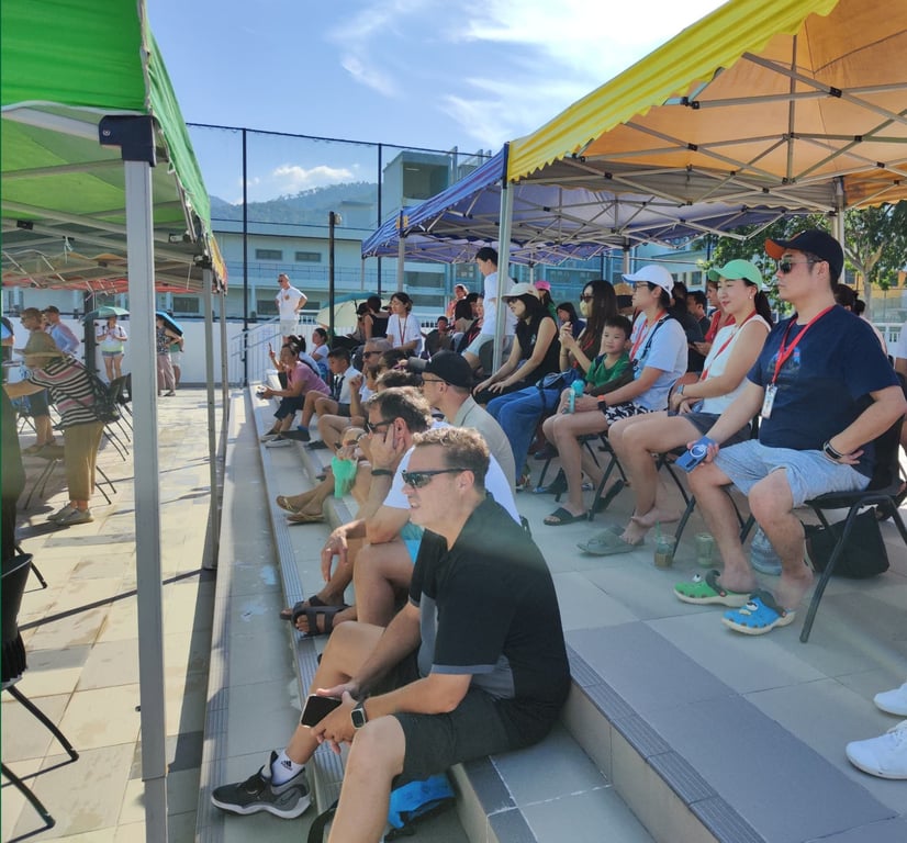 Parents onlooking an event by the school's dragon swim team.