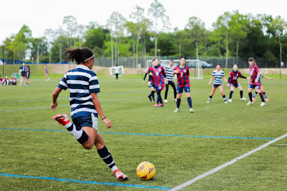 The U15s Girls Football team playing a competitive fixture against another KL international school.