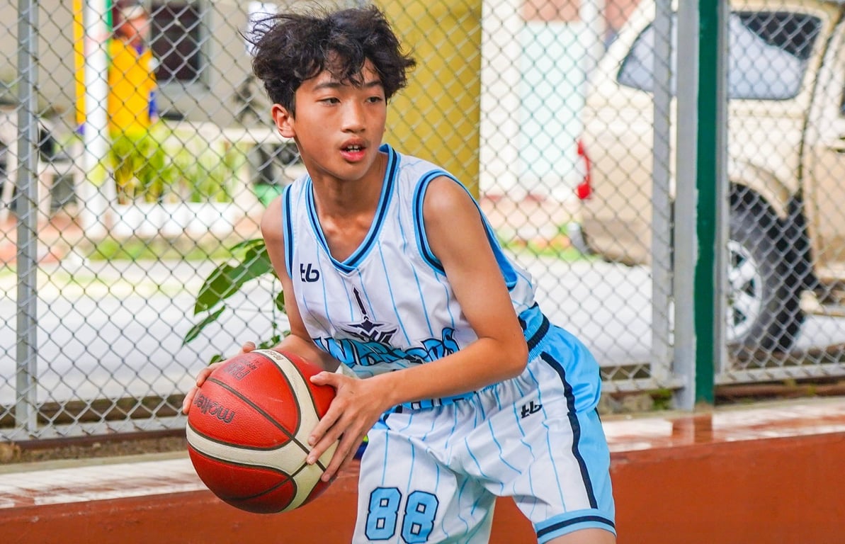 Student athlete holding the ball on the basketball court.