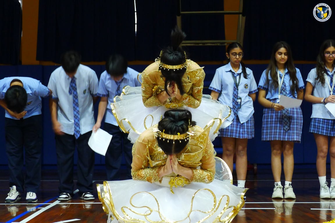 Wai Kru performance featuring traditional Thai attire.