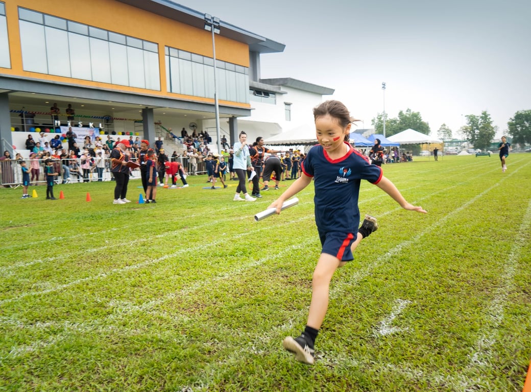Student racing in the relay at MISKL Sports Day 2025.