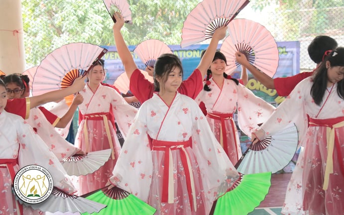 Students performing a traditional fan dance for International Day.