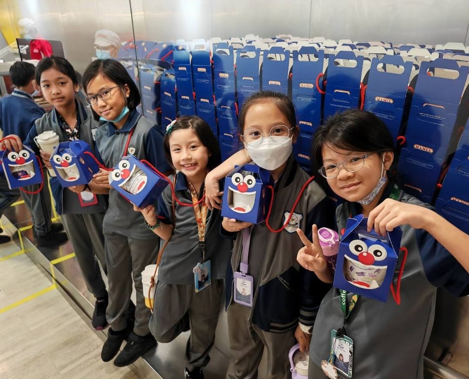 Primary students visiting a production facility, combining learning with real-world insights on packaging and logistics.
