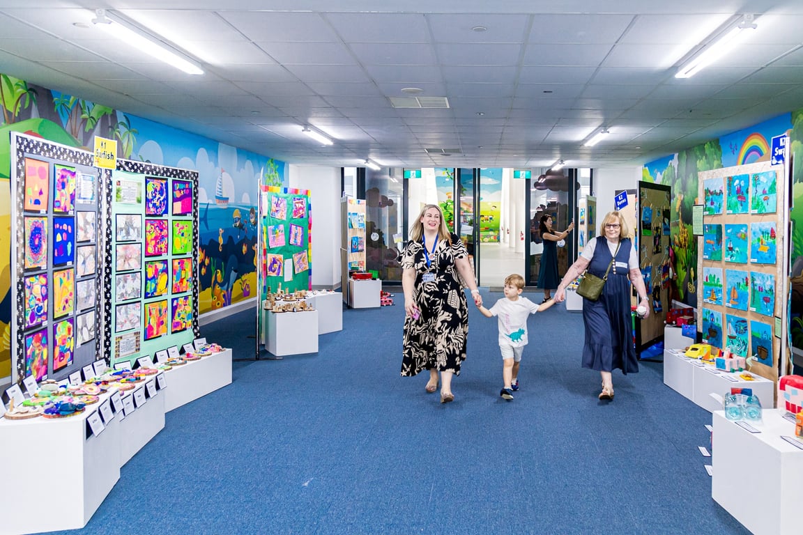 Kindergarten students showcase their artwork to their parents during the Kindergarten Art Exhibition