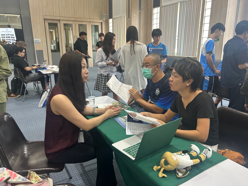 Parents engaging with university representatives during the campus visit event.