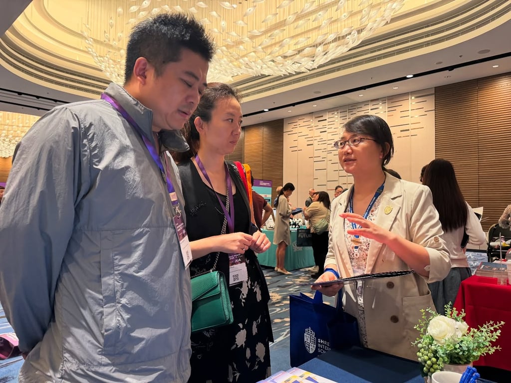 Prospective families being counselled at an international schools fair.