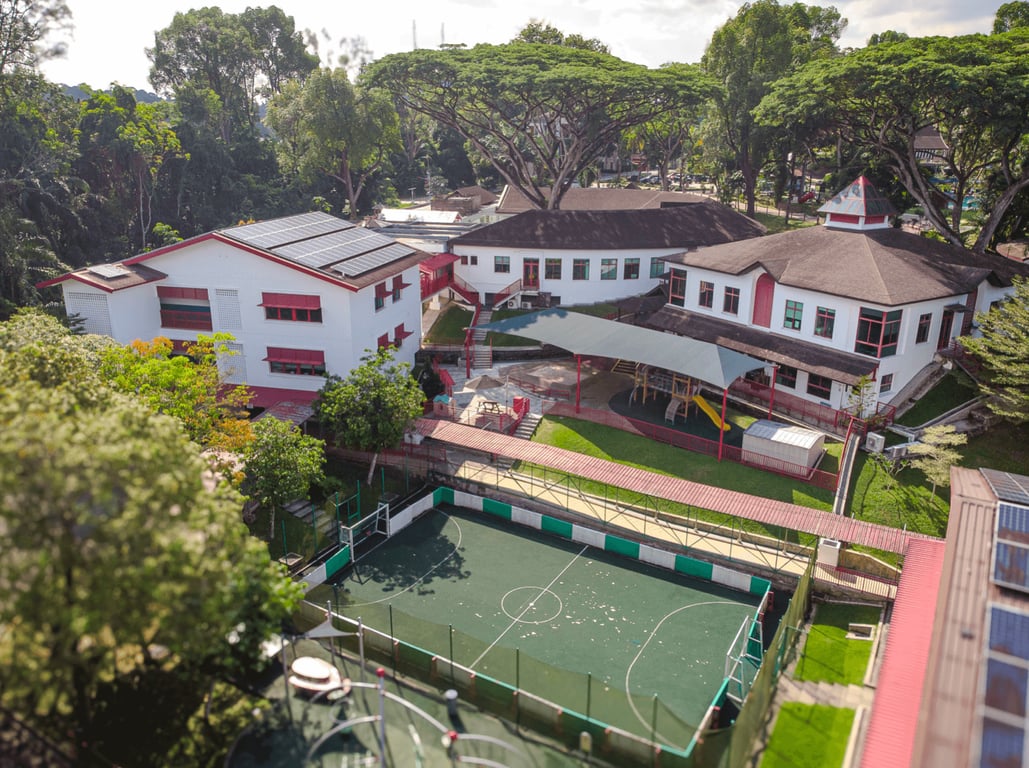 An aerial view of the SSIS campus buildings and the sports pitch