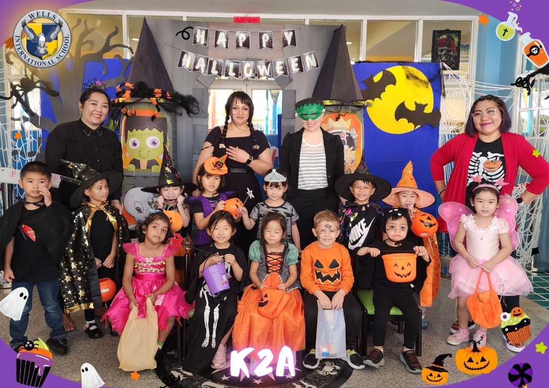K2A class posing in costume for Halloween celebrations.