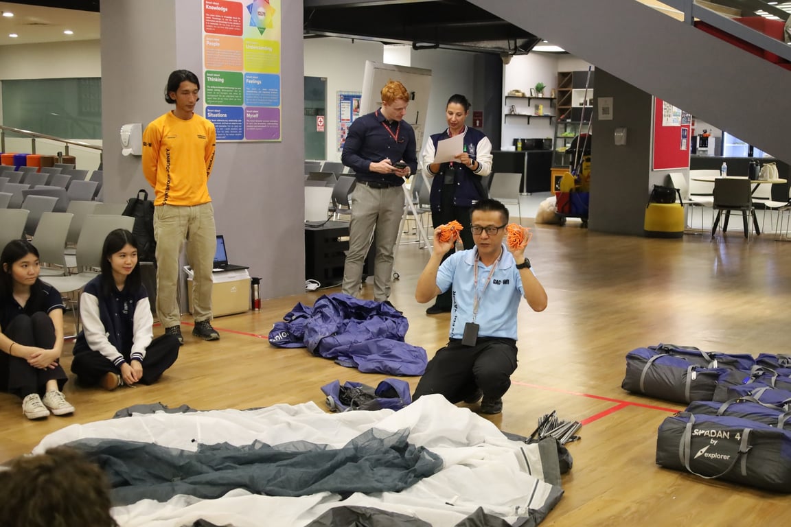 Duke of Edinburgh adventurers take in a tent briefing ahead of their Expedition module.
