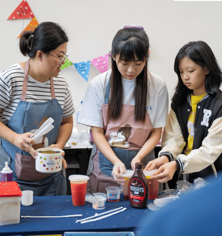 Students try their hand at preparing treats during a school fair activity.