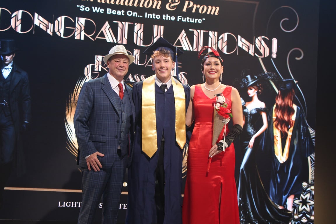 Graduate pictured with staff at the Lighthouse School ceremony.