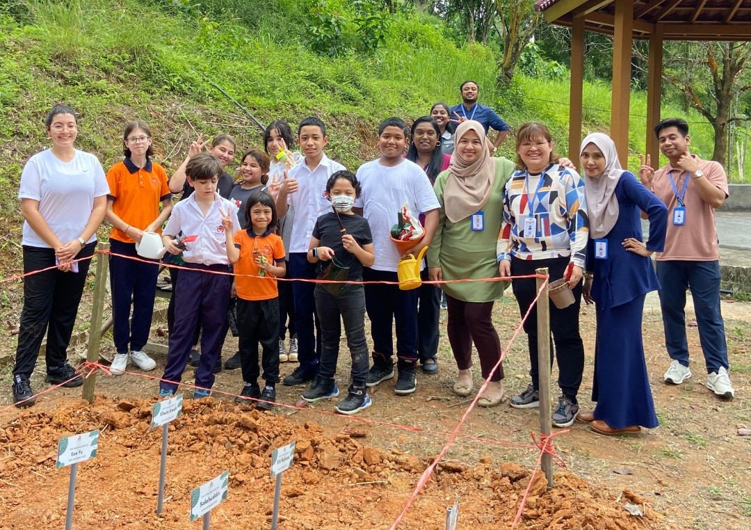 Students and teachers gather together to celebrate TPIS Green Day by planting a new community garden