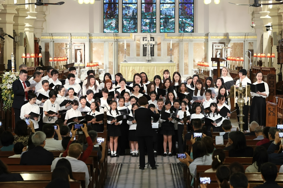 The school choir performs harmoniously in a community concert.