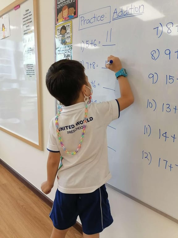 A student contributing on the whiteboard during a Maths lesson