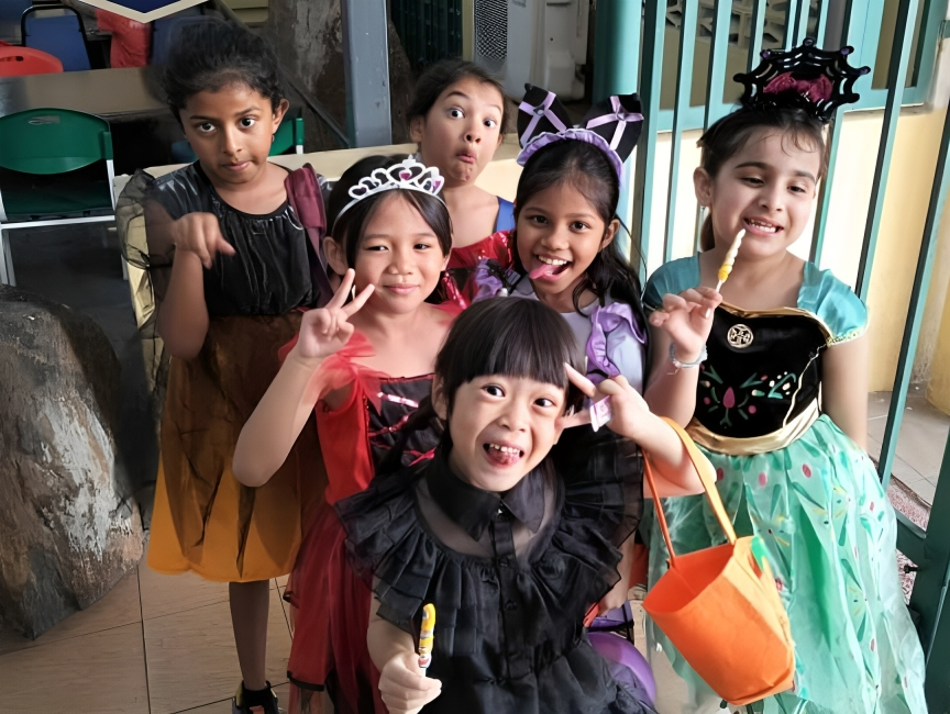 Primary students celebrating Halloween in themed outfits.