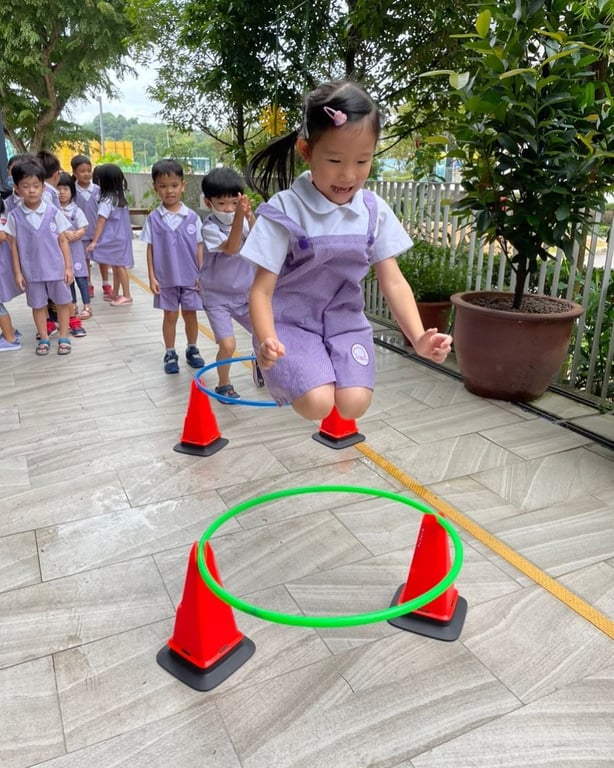 A student jumping during this obstacle course challenge