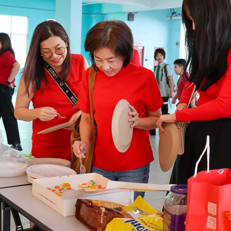 Parents checking the variety of festive dishes at the Lunar New Year celebration.