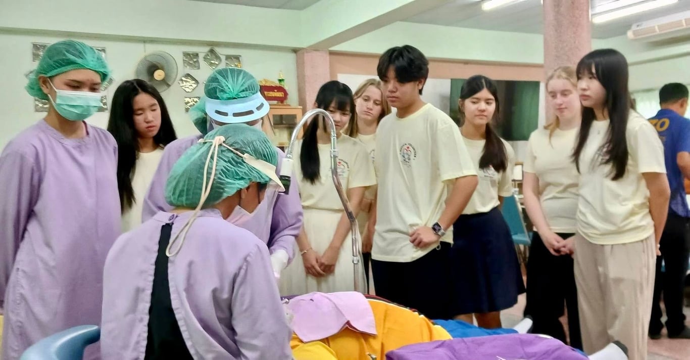 Regent’s Medical Volunteer Society observing medical procedures during a hospital outreach visit.