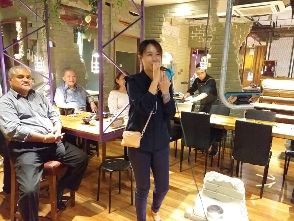 Parents wenjoy each other's company at the  annual Korean New Year dinner event.