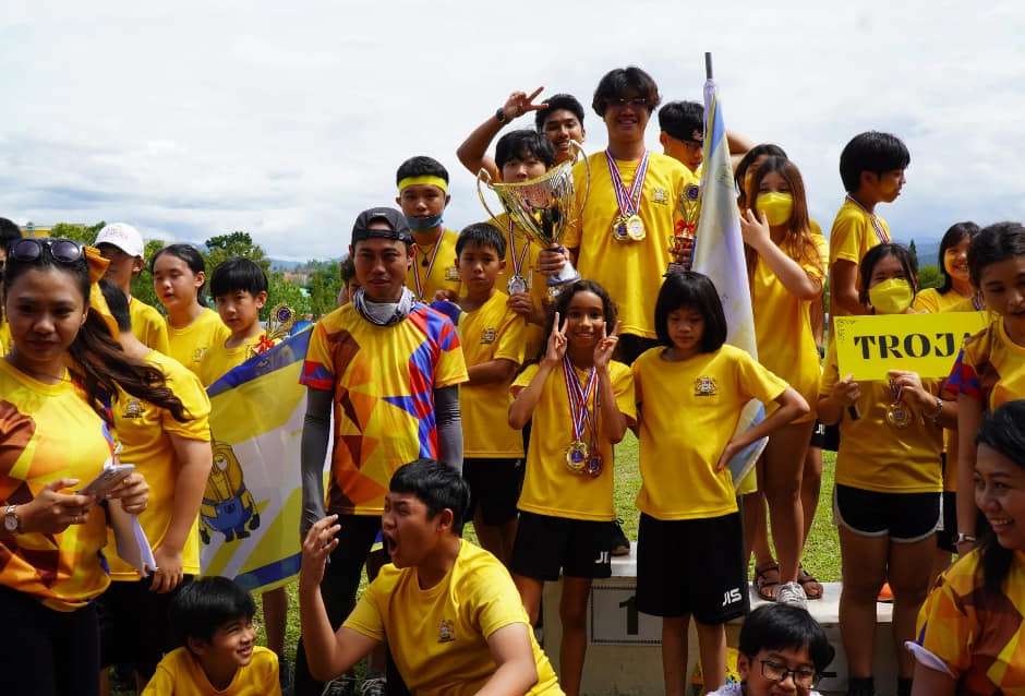 Team Trojans celebrate their victory at Sports Day with medals, trophies, and team pride during a spirited inter-house competition.