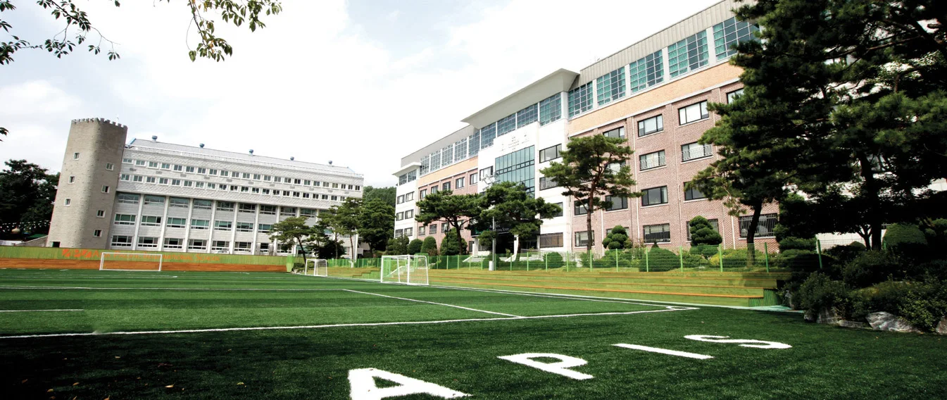 Asia Pacific International School Seoul campus overlooking the outdoor sports field.