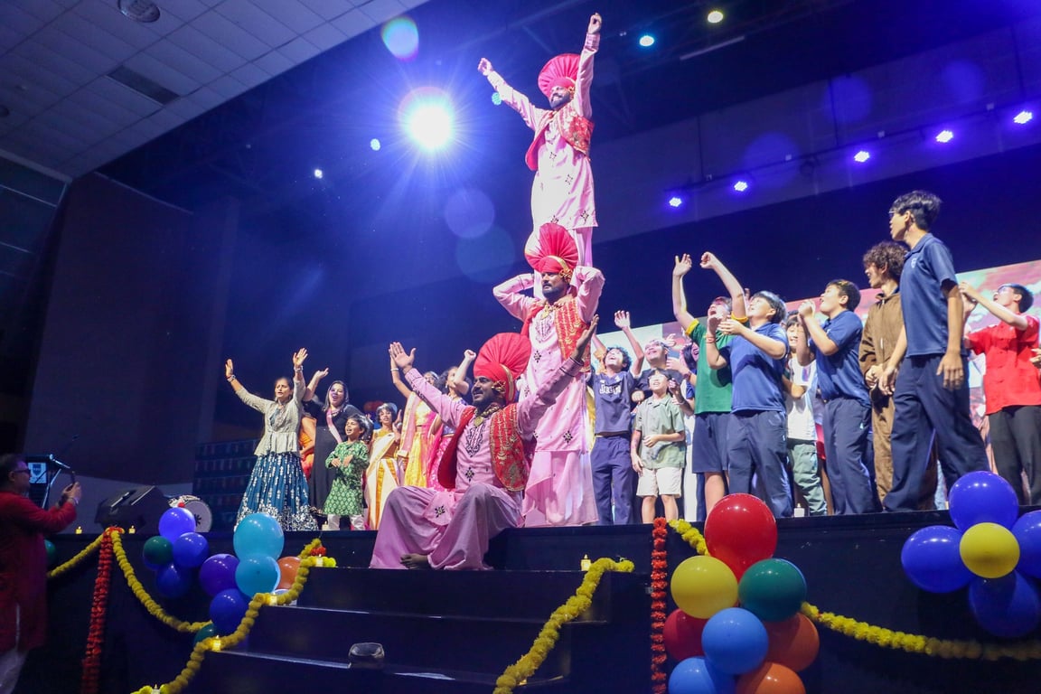 Students and staff join performers on stage at the International Day Celebration.