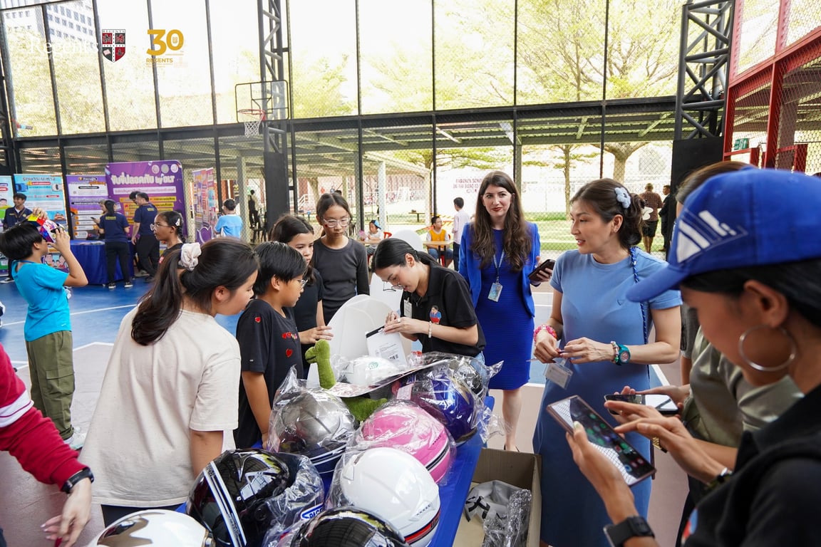 Students and parents engaging with road safety booths at  Bangkok Schools on the Road to Safety event .