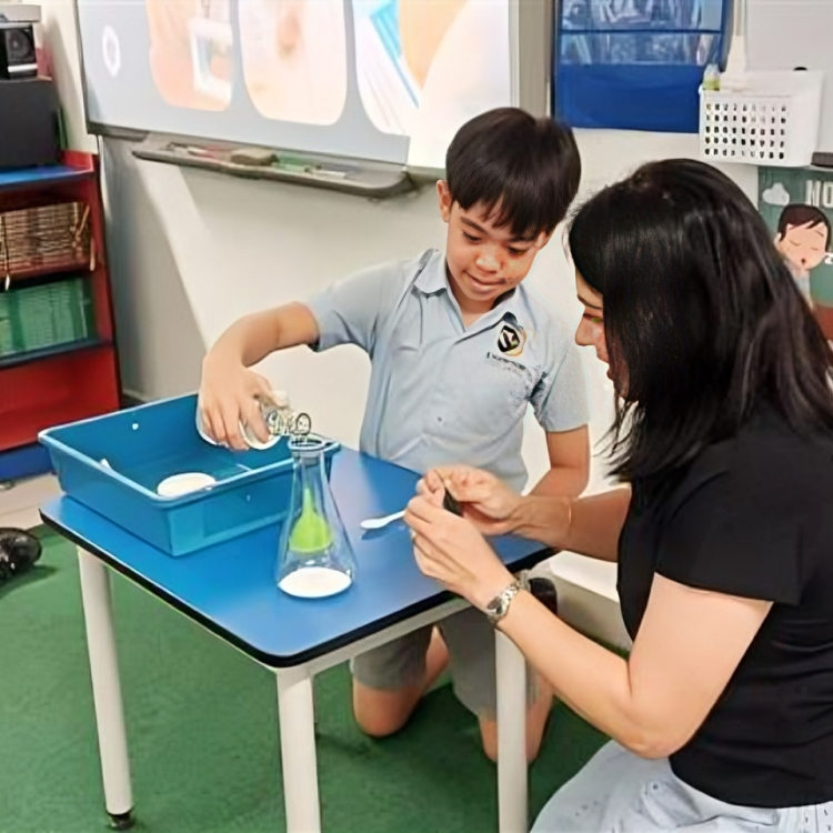 Young scientists at Knewton explore reactions through a hands-on classroom experiment with their teacher.