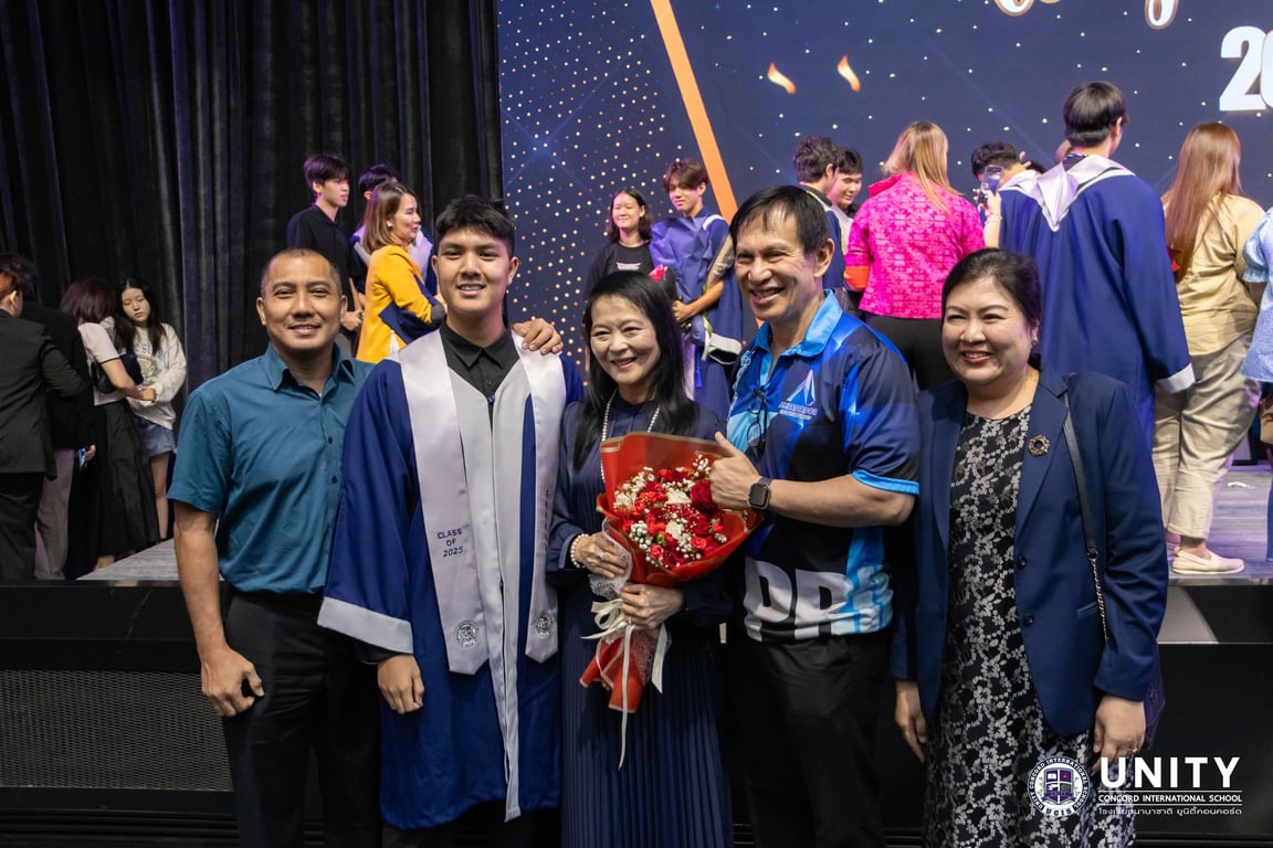 A graduate posing with their family at the graduation ceremony.