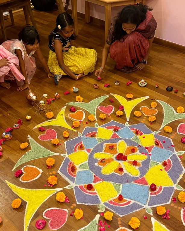 Students decorating a rangoli together during Deepavali, the Hindu Festival of Lights.