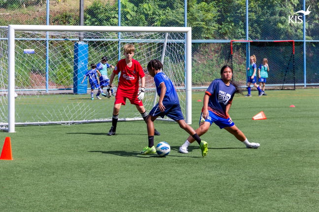 Players practicing 1v1 drills during Day 1 of KIS football camp.