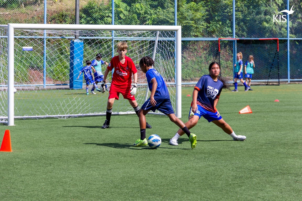 Players practicing 1v1 drills during Day 1 of KIS football camp.
