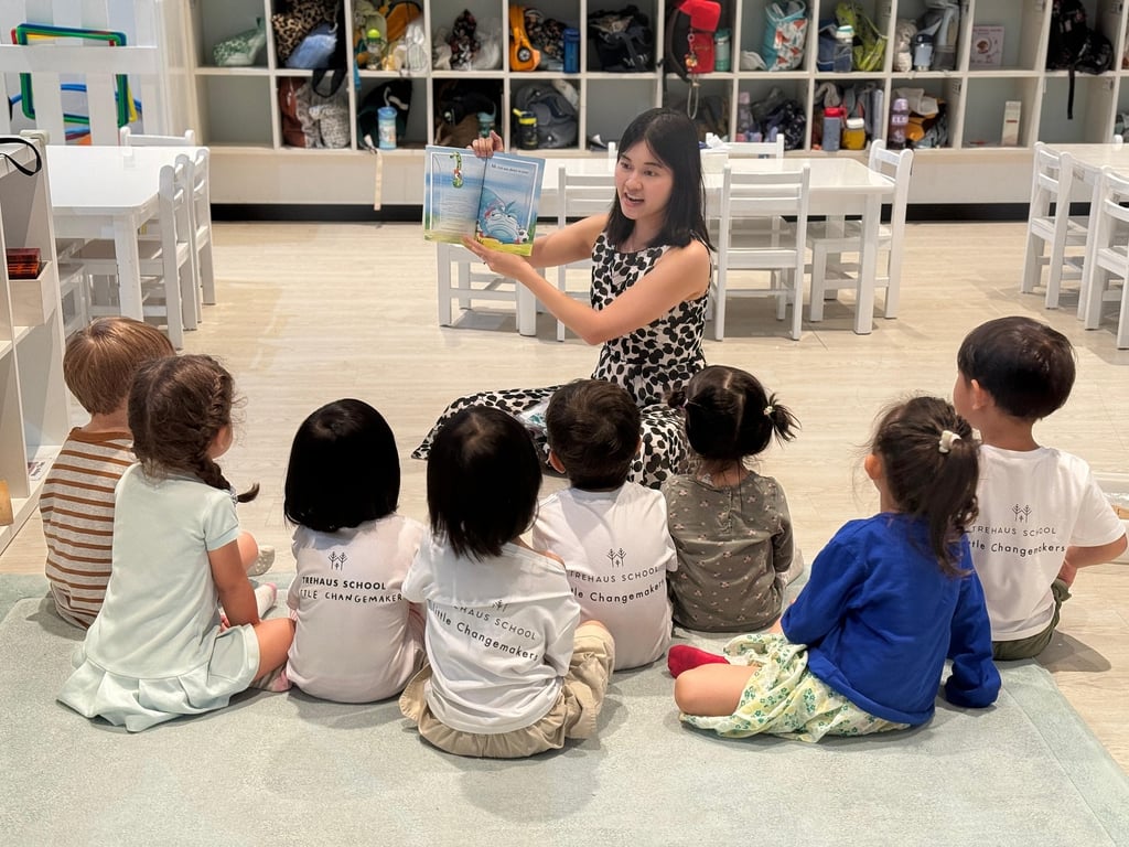 Students gathered for a story in an activity aimed to encourage reading, led by Ms. Xian Hui, a certified speech therapist