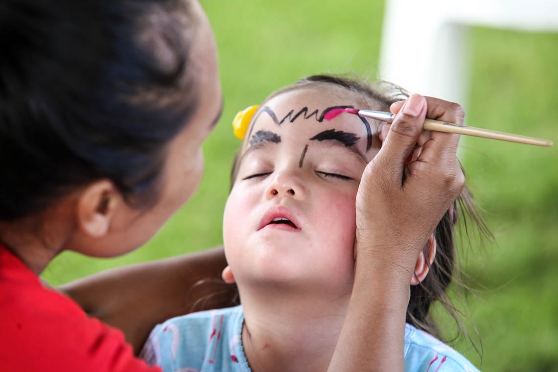 Student enjoying face painting at the ISC Open Day Fair.